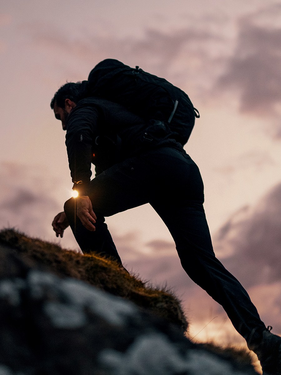 Ant Middleton ascending a ridge at sunset